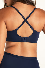 Three-quarter view of the Base Balconette in Navy, showing the structured cup detail and strap placement
