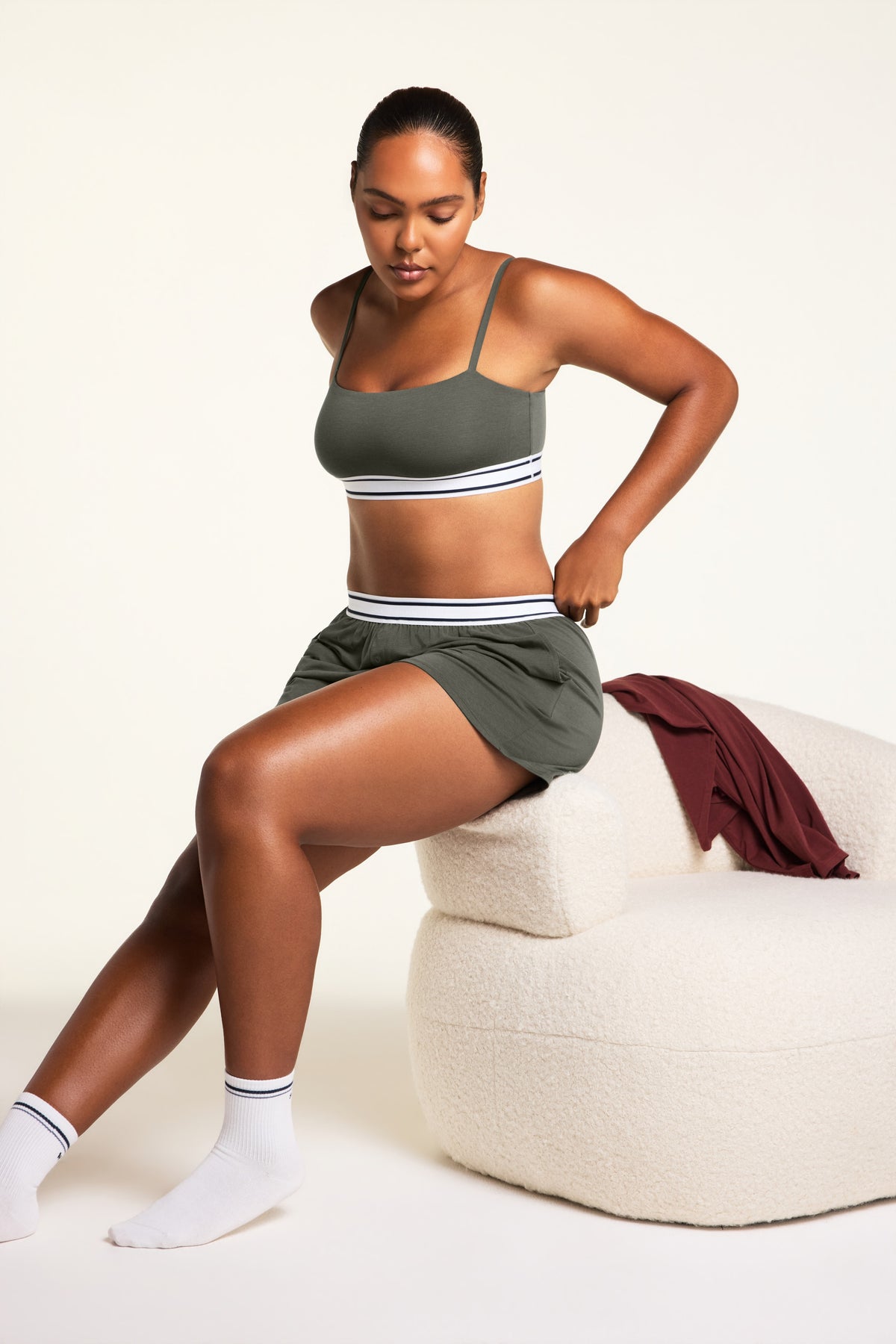 Editorial on-model shot of the Cloud Cotton Bandeau Bralette in Olive styled with the Cloud Cotton Short in Olive.