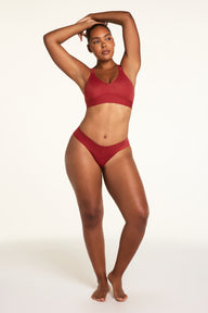 Back on-model view of the Bliss Low Rise Bikini in Ruby paired with the BlissSmooth Bralette in Ruby.