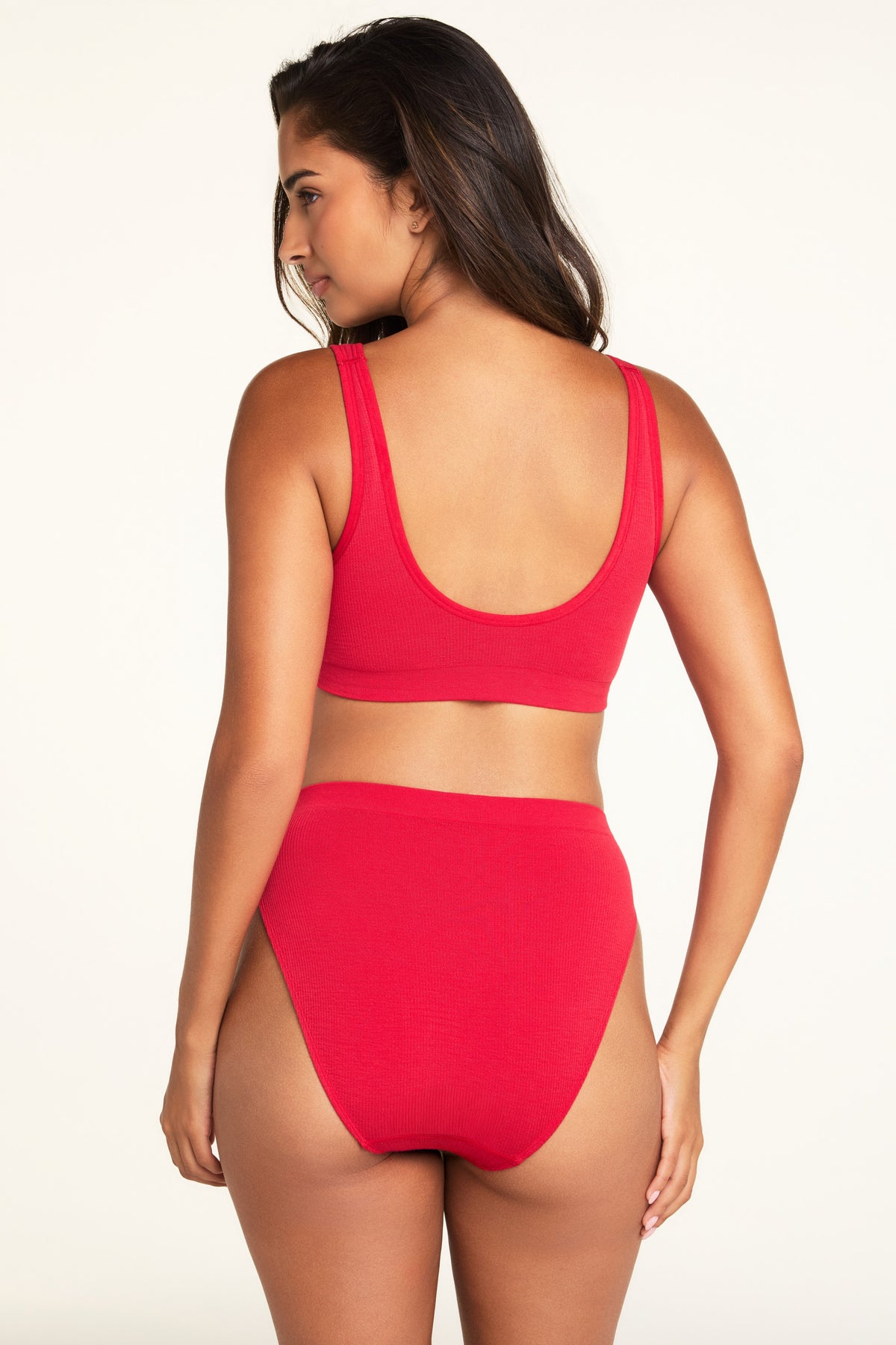 Back on-model view of the Knit Seamless French Cut Brief in Cherry paired with the Knit Seamless Bralette in Cherry.