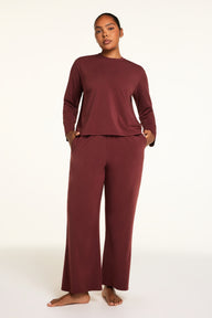 Back on-model view of the Cloud Cotton Long Sleeve T-Shirt in Cabernet paired with the Cloud Cotton Pant in Cabernet.