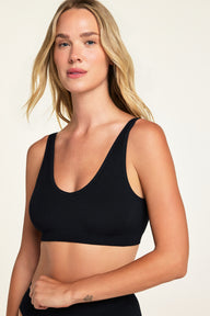 Back on-model view of the Knit Seamless Bralette in Black paired with the Knit Seamless French Cut Brief in Black.