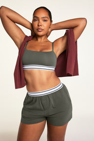 Editorial on-model shot of the Cloud Cotton Bandeau Bralette in Olive styled with the Cloud Cotton Short in Olive.