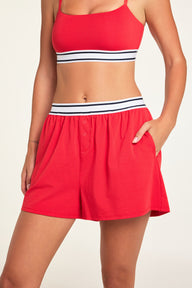 Close-up detail of the Cloud Cotton Short in Cherry paired with the Cloud Cotton Bandeau Bralette in Cherry.
