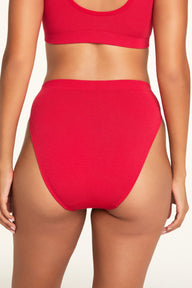 Close-up detail of the Knit Seamless French Cut Brief in Cherry paired with the Knit Seamless Bralette in Cherry.