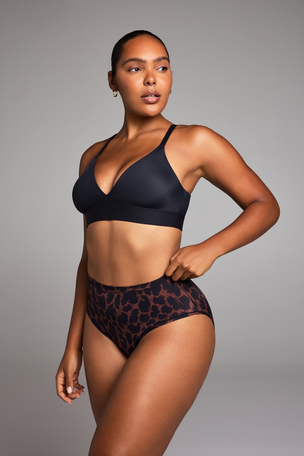 Editorial on-model shot of the Bliss Triangle Bralette in Black styled with the Bliss Highwaist Brief in Leopard.