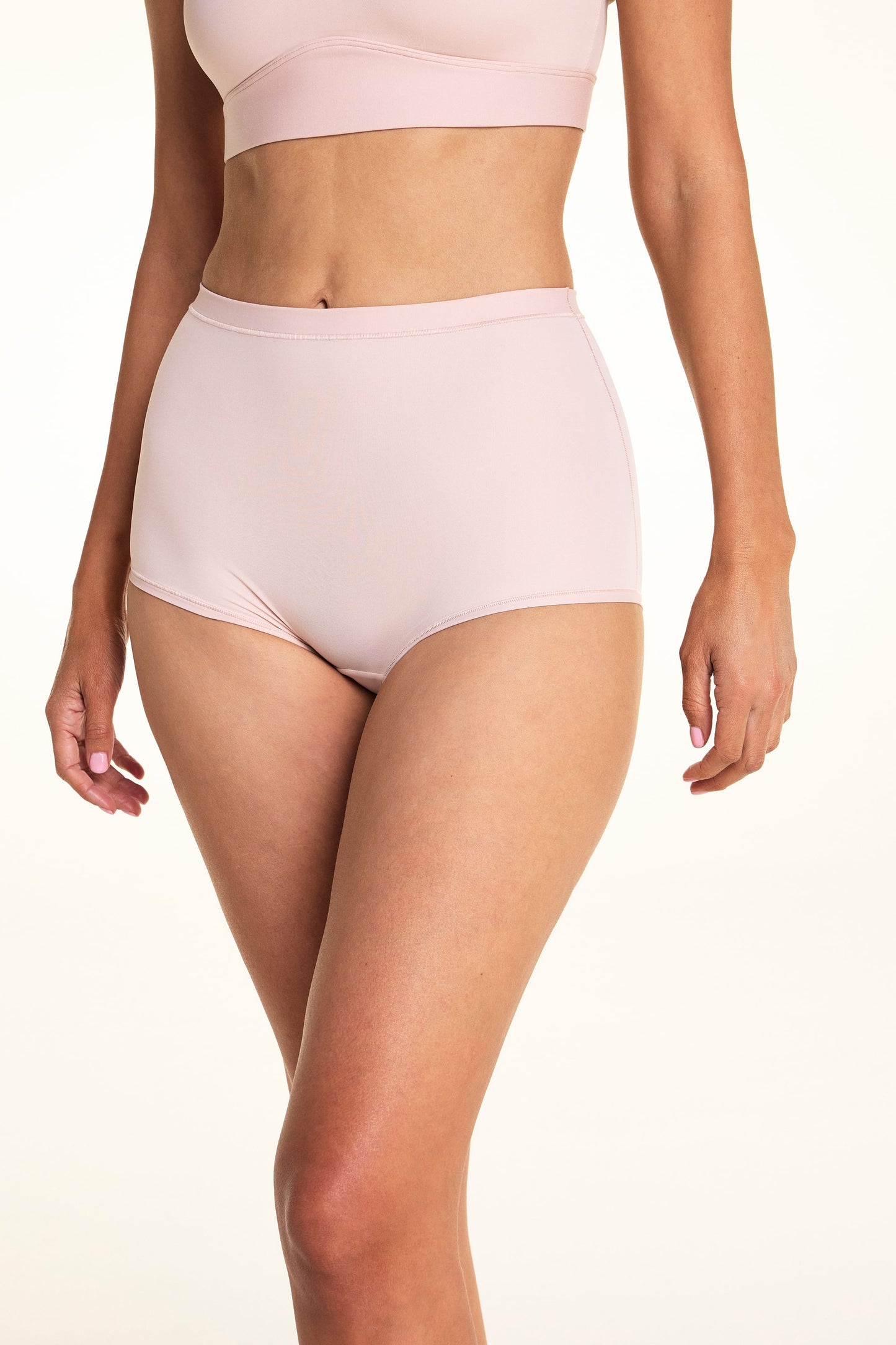 On a light studio backdrop, Meagan wears the Bliss Boyshort in Ember Rose. The front view highlights the mid-rise waist, full-coverage silhouette, smooth fabric, and soft waistband. sizing: Meagan wears size Small