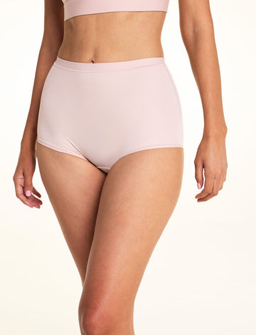 On a light studio backdrop, Meagan wears the Bliss Boyshort in Ember Rose. The front view highlights the mid-rise waist, full-coverage silhouette, smooth fabric, and soft waistband. sizing: Meagan wears size Small