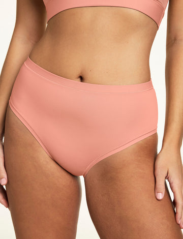 In a close-up studio image, Sonnie wears the Bliss Brief in Cabana with the Bliss bralette, highlighting the smooth fabric, high-rise silhouette, and soft waistband.  sizing: Sonnie wears size Large