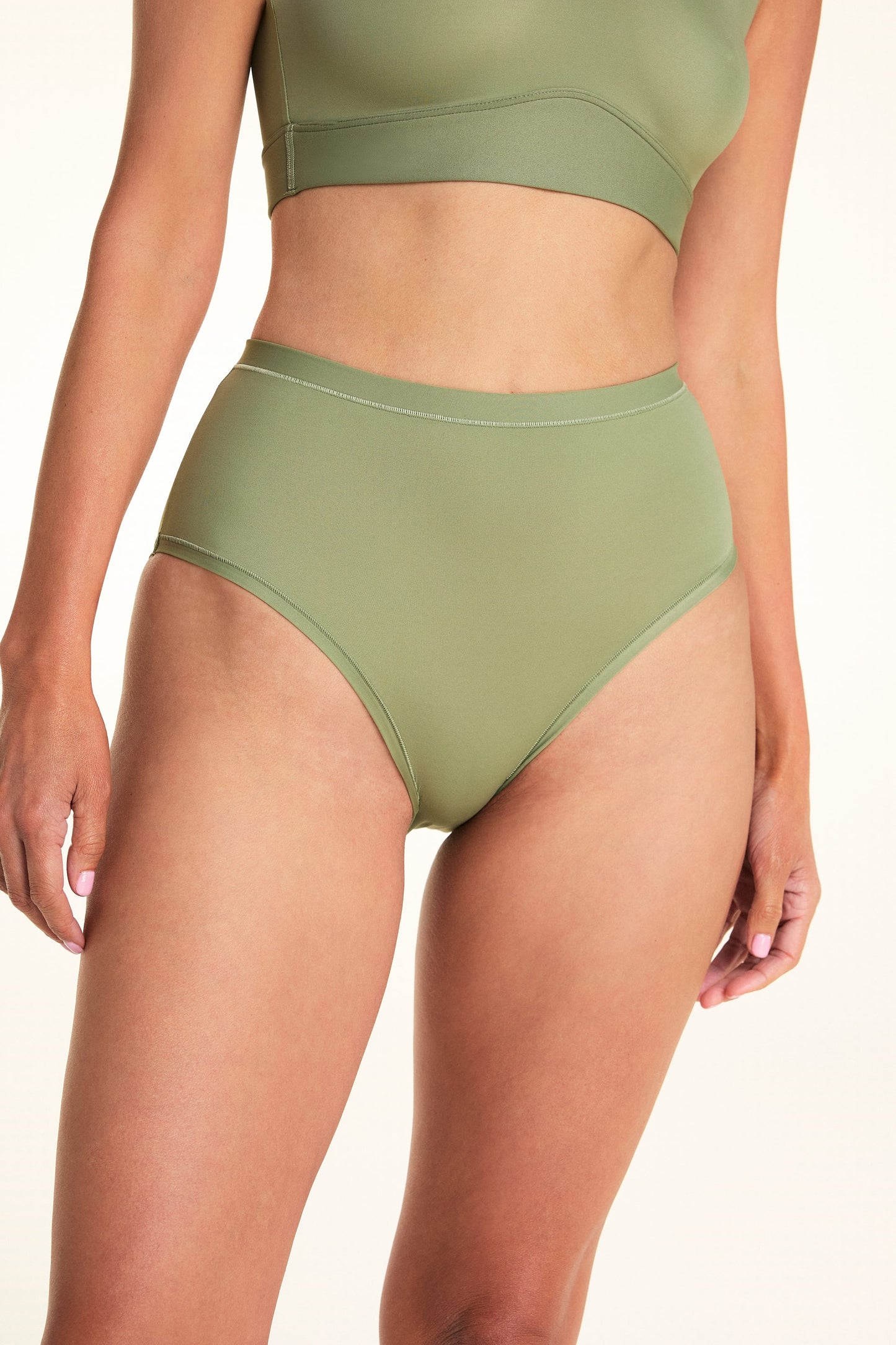 Close-up of Meagan wearing the Bliss Highwaist Brief in Dill. The high-waist brief features a high-rise waist, full coverage, and a smooth microfiber finish. sizing:  Meagan wears size Small


