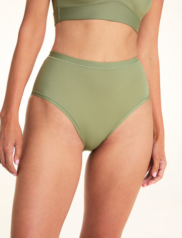 Close-up of Meagan wearing the Bliss Highwaist Brief in Dill. The high-waist brief features a high-rise waist, full coverage, and a smooth microfiber finish. sizing:  Meagan wears size Small


