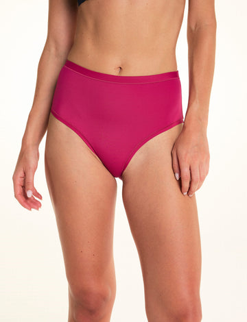 On a light studio backdrop, Alexis wears the Bliss Highwaist underwear in Winterberry. The front view highlights the high-rise silhouette, smooth fabric, and full-coverage design. sizing: Alexis wears size Small