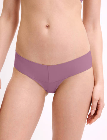 In a studio setting, a model wears the Bliss Low Rise Bikini in Mirage, shown in a close-up front view. The bikini features a low-rise fit, minimal coverage, and smooth, seamless fabric. sizing: Megan wears size Small