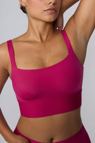 In a studio setting, India wears the Bliss Square Neck Bralette in Winterberry. A close-up front view highlights the square neckline, wide straps, smooth fabric, and supportive underband. sizing: India wears size Large