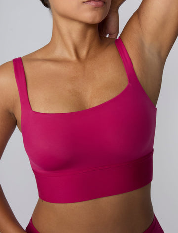 In a studio setting, India wears the Bliss Square Neck Bralette in Winterberry. A close-up front view highlights the square neckline, wide straps, smooth fabric, and supportive underband. sizing: India wears size Large