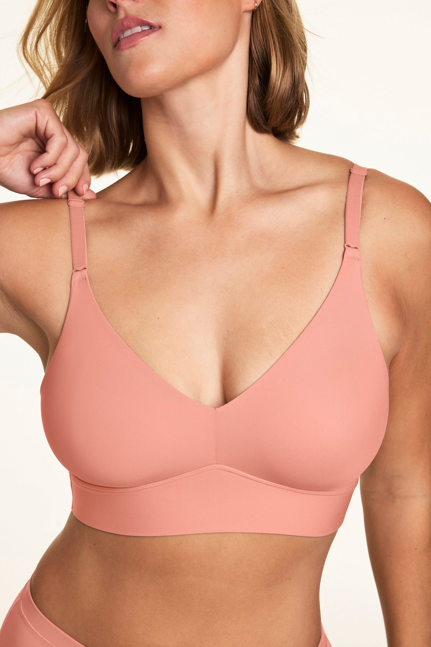 In a close-up studio image, Sonnie wears the Bliss Triangle Bralette in Cabana, highlighting the deep V-neckline, adjustable straps, and smooth comfort band.  sizing: Sonnie wears size Large