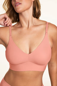 In a close-up studio image, Sonnie wears the Bliss Triangle Bralette in Cabana, highlighting the deep V-neckline, adjustable straps, and smooth comfort band.  sizing: Sonnie wears size Large