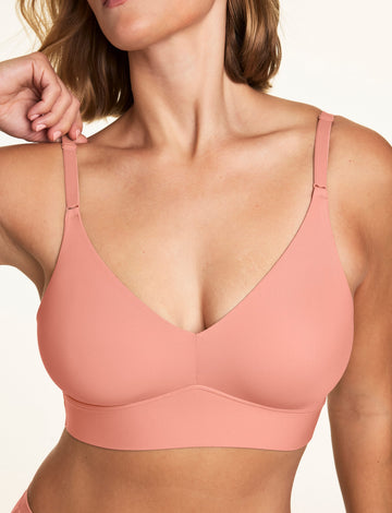 In a close-up studio image, Sonnie wears the Bliss Triangle Bralette in Cabana, highlighting the deep V-neckline, adjustable straps, and smooth comfort band.  sizing: Sonnie wears size Large