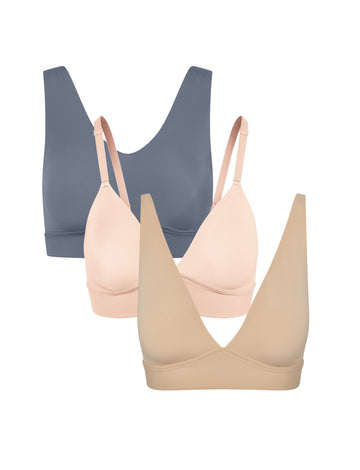 Three wireless bralettes shown in a staggered lineup on a white background, featuring Bliss in Steel, Bliss Triangle in Rose and Bliss Plunge Adjustable in Beige