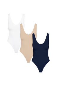 Product shot of Harper Wilde The Bodysuit Trio — three Bliss scoop-neck bodysuits in White, Beige, and Navy, smooth and close-to-body for layering under fall bottoms