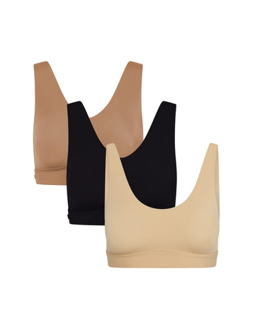 Product shot of Harper Wilde The Everyday Bliss Trio — Bliss Bralette in Tan, Bliss Bralette in Black, and New Bliss Scoop Bralette in Beige, three wireless everyday bralettes in neutral shades