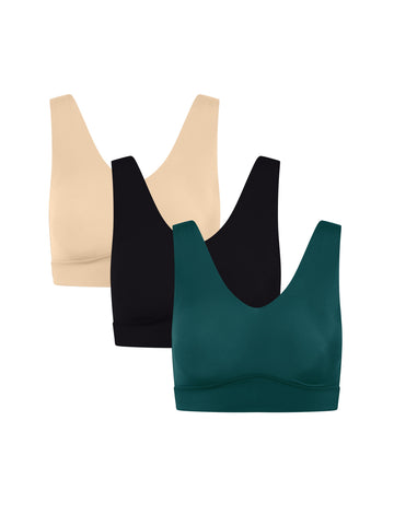 Three wireless Bliss Bralettes in beige, black, and pine, arranged in a staggered overlapping layout on a solid white background.