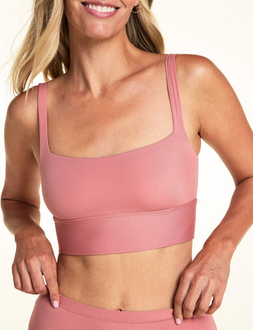 On a light neutral backdrop, Meagan wears the Bliss Squareneck Bralette in Cinnamon with matching underwear. The close-up highlights the square neckline, thin straps, longline band, and smooth microfiber fabric. sizing: Meagan wears size small