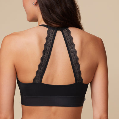 Close up back view of Anna wearing the Bliss Lace Halterneck Bralette in Black showcasing the soft lace detail at the back of the straps.