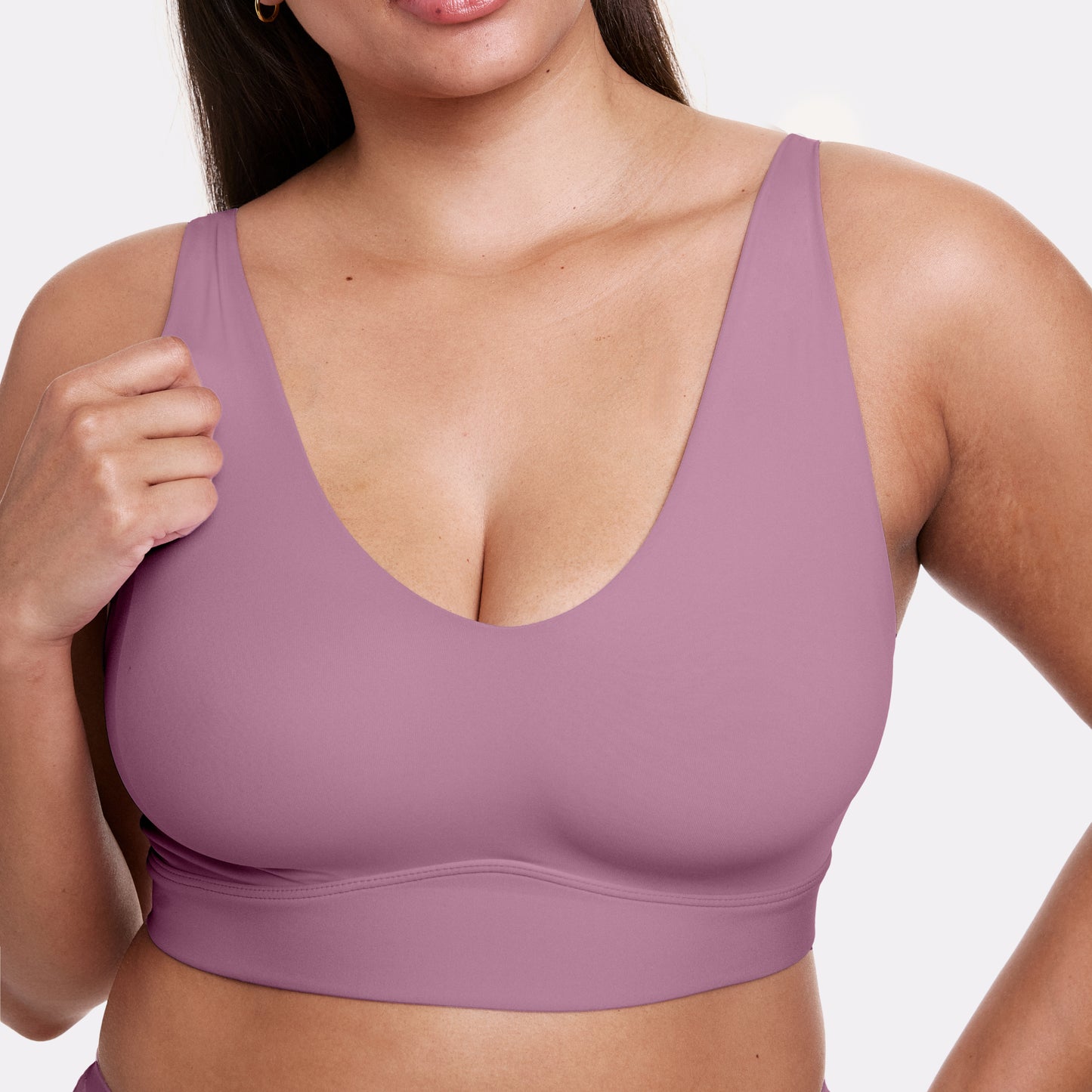 In a studio setting, Alana wears the Bliss Bralette in Mirage, shown in a close-up highlighting the scoop neckline, smooth fabric, and wide underband. The wireless design offers light support.