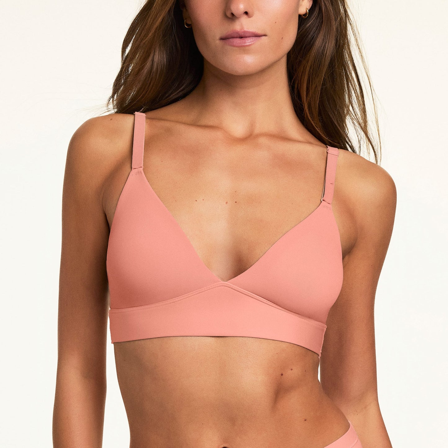 In a close-up studio image, Gianna wears the Bliss Triangle Bralette in Cabana, featuring a deep V-neckline, adjustable straps, and smooth fabric.