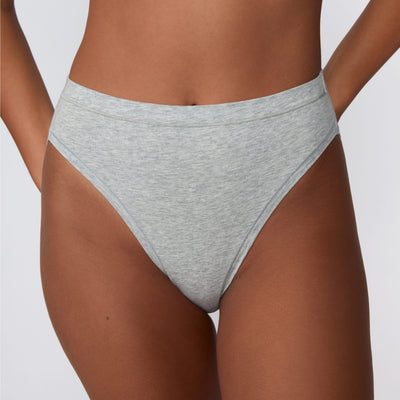 In a studio setting, Courtney wears the Cloud Cotton French Cut Brief in Heather Grey. The square-crop close-up highlights the French-cut leg openings, mid-rise waistband, and soft cotton fabric.