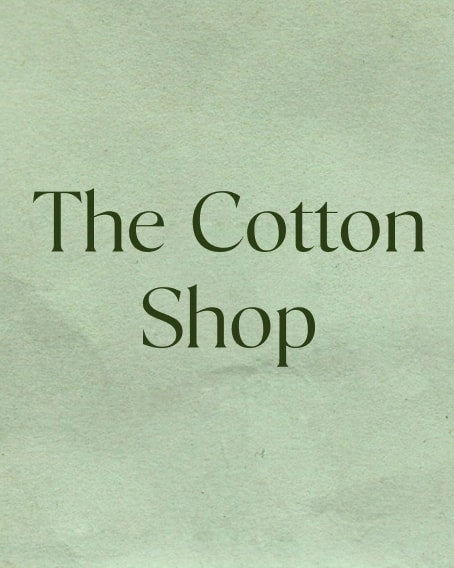 Sage green crumpled paper background with text: "The Cotton Shop"