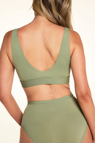 Back view of Meagan wearing the Bliss Bralette in Dill with matching underwear. The wireless bralette features a low scoop back, wide straps, and a smooth underband.