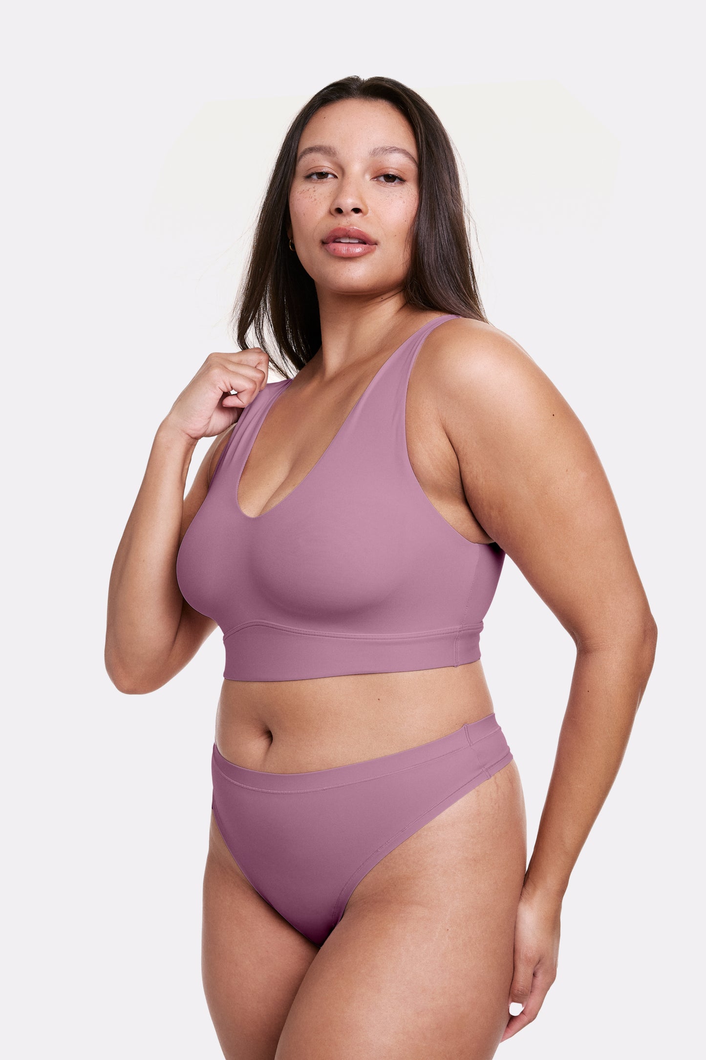 In a studio setting, Alana wears the Bliss Bralette in Mirage paired with matching underwear, shown in a full-body view. The bralette features wireless cups, a scoop neckline, and a wide underband for everyday comfort.