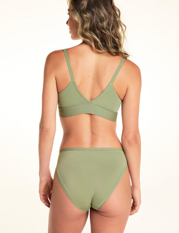 Back view of Alexis wearing the Bliss French Cut Brief in Dill. The brief features a high-rise waist, full back panel, and a smooth microfiber finish.