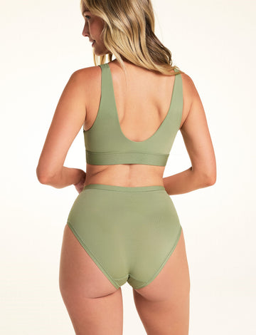 Back view of Meagan wearing the Bliss Highwaist Brief in Dill with the matching Bliss Bralette. The brief features a high-rise waist, full back coverage, and a smooth microfiber finish.