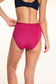 On a light studio backdrop, Alexis wears the Bliss Highwaist underwear in Winterberry. The back view showcases the high-rise fit, smooth fabric, and full back coverage.