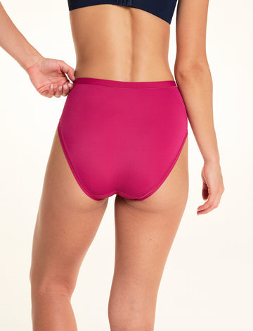 On a light studio backdrop, Alexis wears the Bliss Highwaist underwear in Winterberry. The back view showcases the high-rise fit, smooth fabric, and full back coverage.