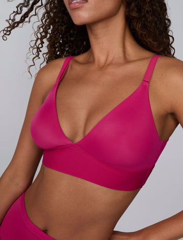 In a studio setting, Courtney wears the Bliss Triangle Bralette in Winterberry. A close-up view highlights the deep V-neckline, smooth molded cups, adjustable straps, and wide underband.