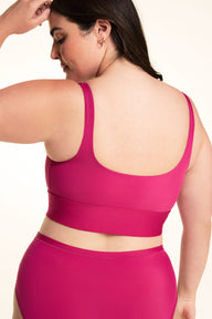 On a light studio backdrop, Alessandra wears the Bliss Square Neck Bralette in Winterberry. The back view showcases the scoop-back design, wide straps, and smooth comfort band.