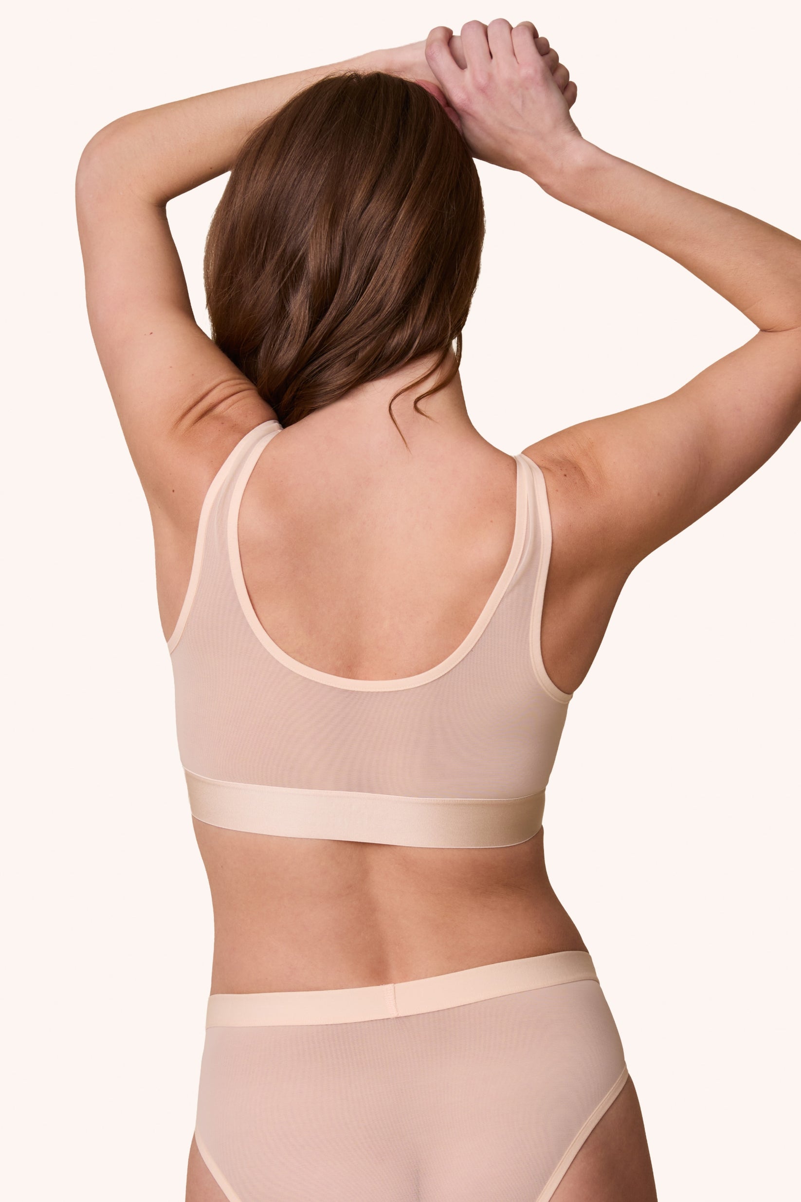 Rear view of the ComfortMesh™ Scoop Bralette in Pearl on a model. The back scoop neckline and smoothing band emphasize the supportive yet barely-there design.