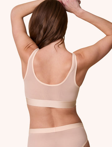 Rear view of the ComfortMesh™ Scoop Bralette in Pearl on a model. The back scoop neckline and smoothing band emphasize the supportive yet barely-there design.