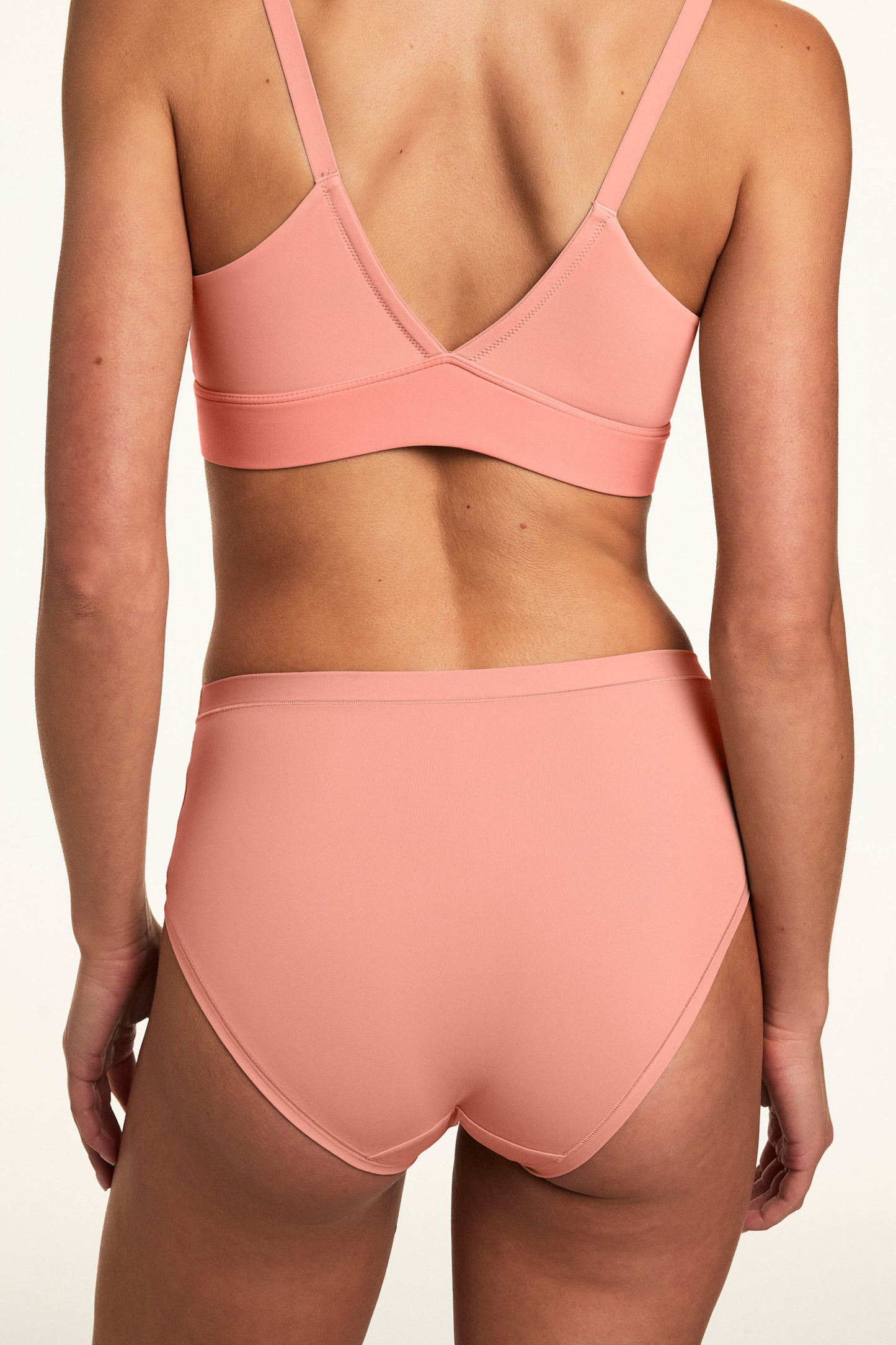 From the back, Gianna wears the Bliss Brief in Cabana with the matching Bliss bralette, showcasing the full-coverage back, smooth fabric, and soft  swaistband. sizing: Gianna wears size Small