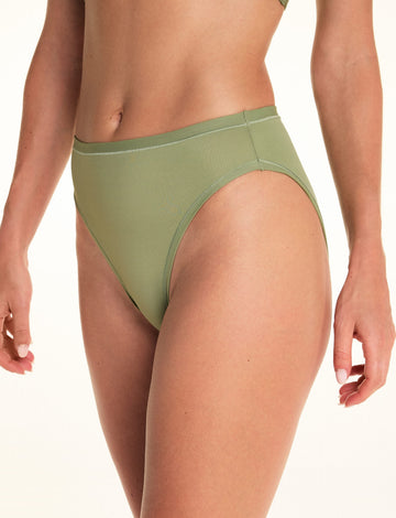 Three-quarter close-up of Alexis wearing the Bliss French Cut Brief in Dill. The French cut silhouette features a high-rise waist, high-cut leg openings, and a smooth microfiber finish. sizing: Alexis wears size Small