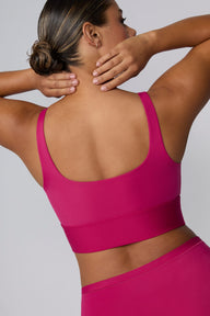 On a light gray studio backdrop, India wears the Bliss Square Neck Bralette in Winterberry. A back view highlights the scoop-back design, wide straps, and supportive underband.