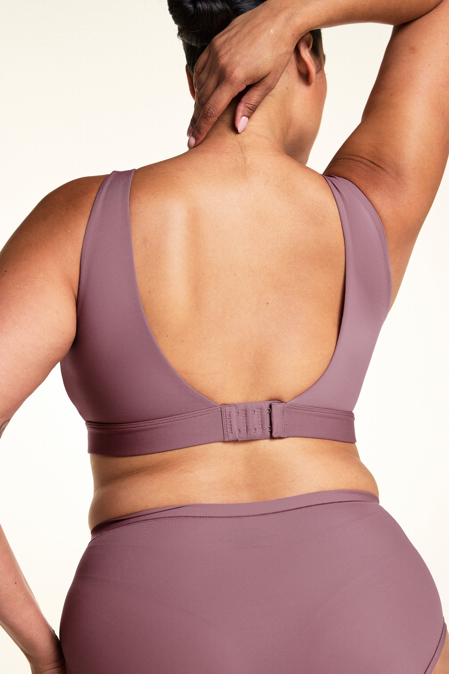 Lifestyle shot of model wearing the Bliss Scoop Adjustable Bralette in Mirage with the Bliss Highwaist Brief, showing the full supportive wireless fit