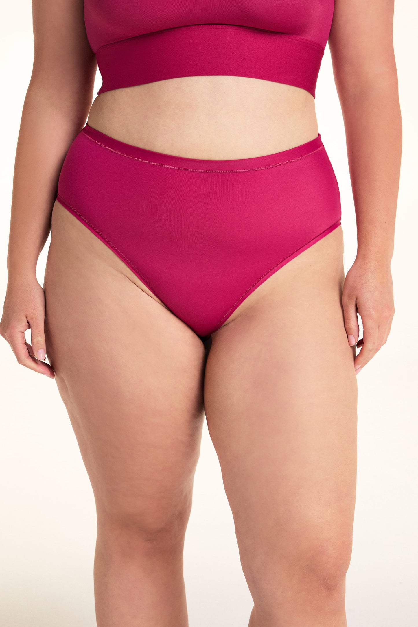 On a light studio backdrop, Alessandra wears the Bliss Highwaist underwear in Winterberry paired with the Bliss Square Bralette. The front view highlights the high-rise silhouette, smooth fabric, and full-coverage design. sizing: Alessandra wears size Large
