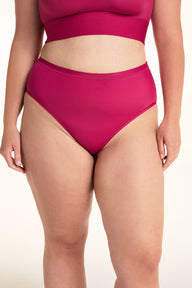 On a light studio backdrop, Alessandra wears the Bliss Highwaist underwear in Winterberry paired with the Bliss Square Bralette. The front view highlights the high-rise silhouette, smooth fabric, and full-coverage design. sizing: Alessandra wears size Large