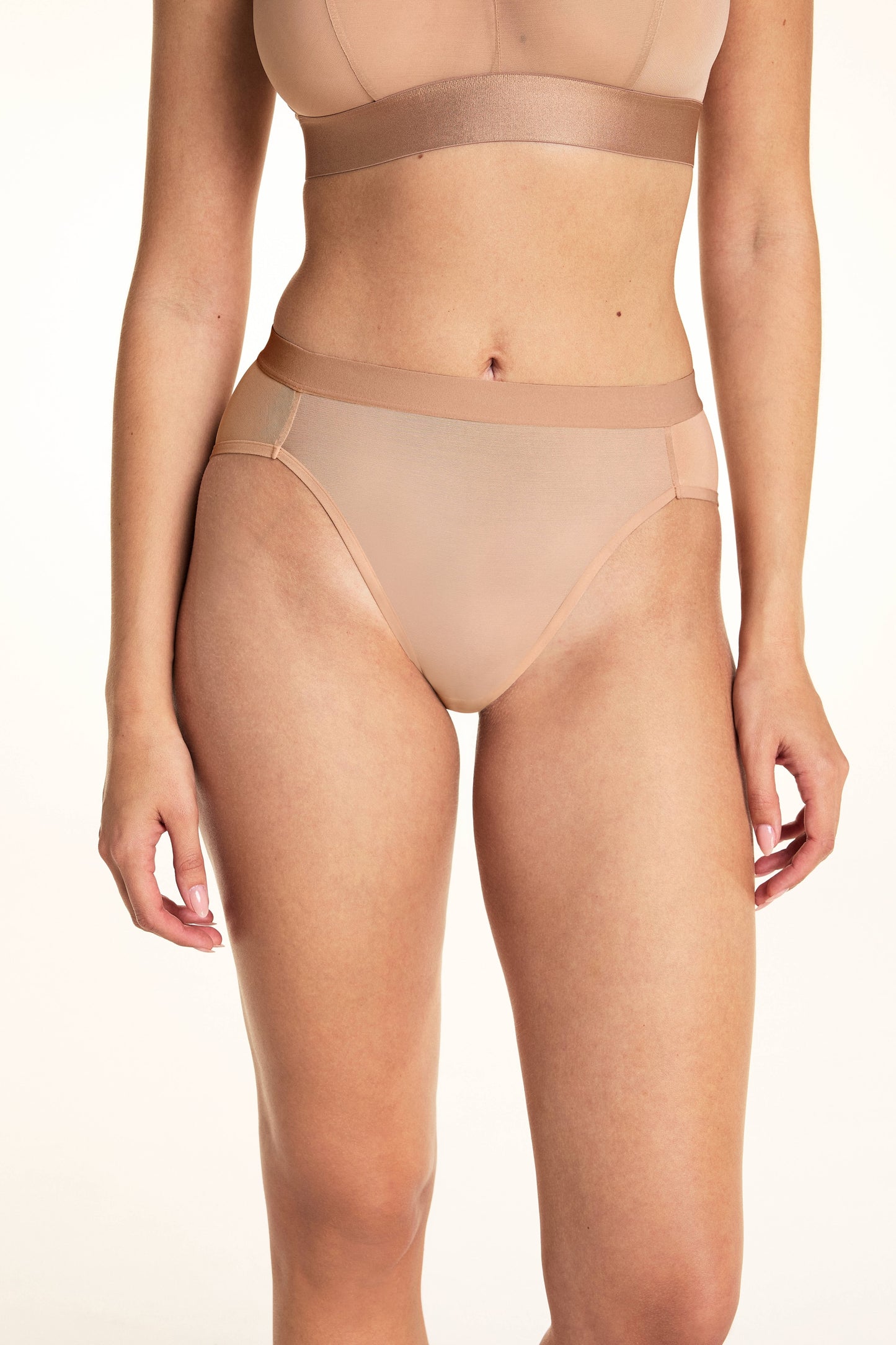 Close up front view of the ComfortMesh Highwaist Brief in Taupe showing the high cut leg opening. sizing: Laura wears size Small