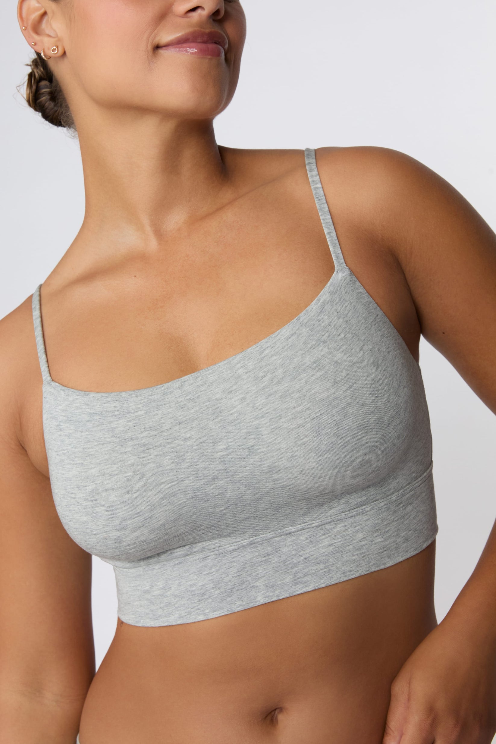 In a studio setting, India wears the Cloud Cotton Thin Strap Bralette in Heather Grey with matching underwear. The close-up view highlights the straight neckline, thin adjustable straps, and wide underband.